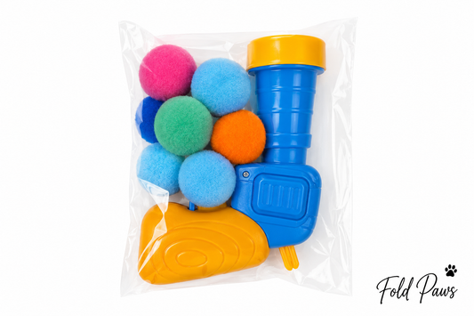 Fold Paws interactive pom-pom ball launcher toy set with colorful pom-poms
